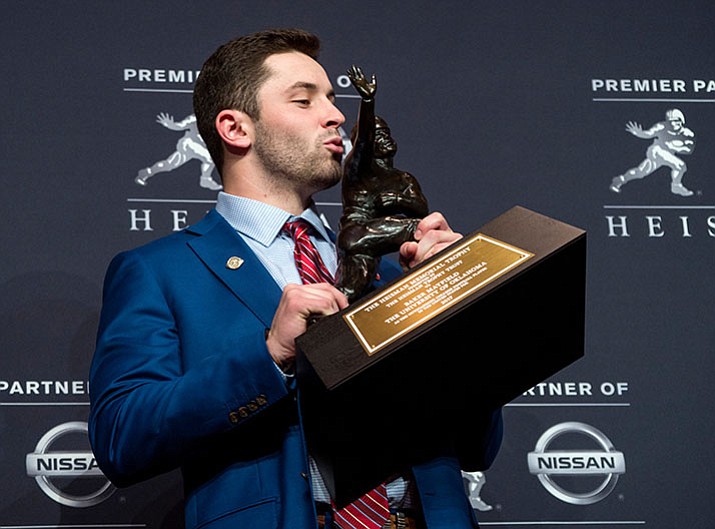 Oklahoma quarterback Baker Mayfield, winner of the Heisman Trophy, poses with the trophy Saturday, Dec. 9, in New York. (Craig Ruttle/AP)