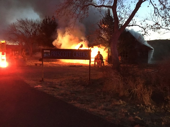 A fire started at this log cabin on Highway 89 and Rosser Street Sunday. Firefighters battled it for nine hours and thought they had it out, but the fire rekindled on Monday.