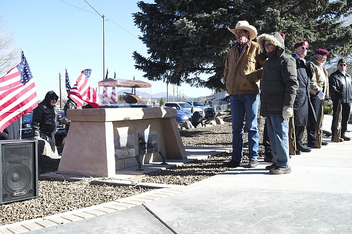 Williams Mayor John Moore and Williams WWII veteran Walter Olmsted standby as a piece of the USS Arizona is revealed at Monument park in Williams Dec. 7. 