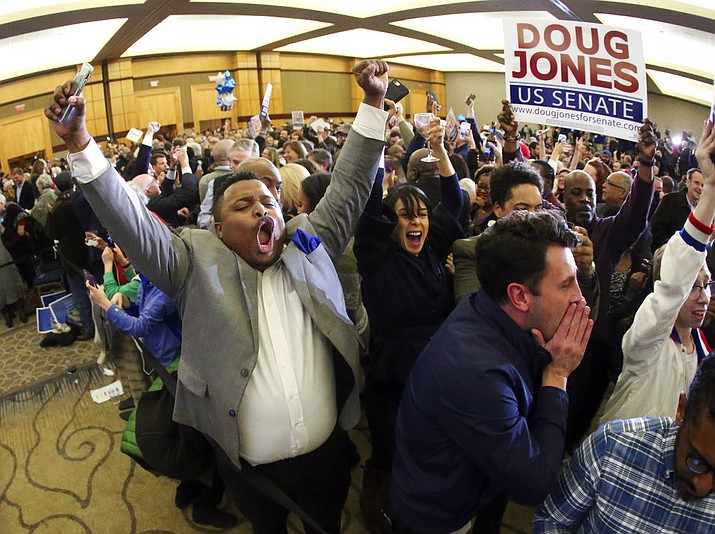 Supporters of Doug Jones erupt is celebration during an election-night watch party Tuesday, Dec. 12, 2017, in Birmingham, Ala. (AP Photo/John Bazemore)
