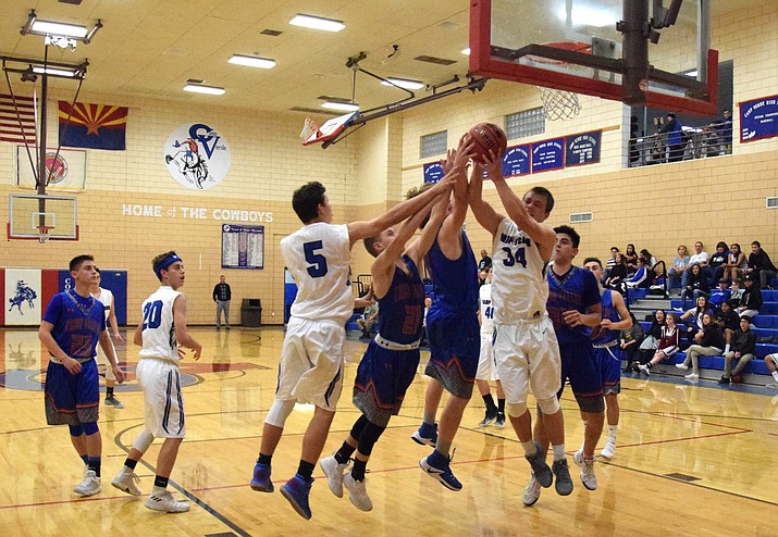 Camp Verde senior Ryan Loza grabs a rebound during the Cowboys’ 64-50 win over Chino Valley at home on Tuesday night at home. (VVN/James Kelley)