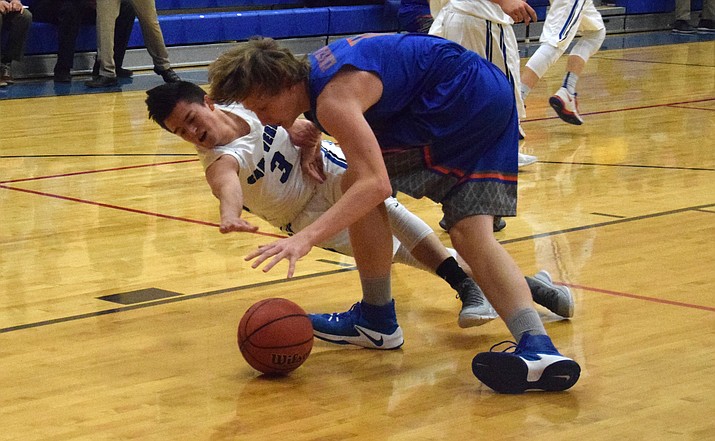Camp Verde junior Ismael Hogan goes for a loose ball against a Cougar during the Cowboys’ 64-50 win over Chino Valley at home on Tuesday night at home. (VVN/James Kelley)
