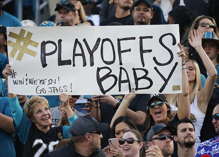 Fans hold up a sign as they cheer for the Jacksonville Jaguars during an NFL football game against the Houston Texans, Sunday, Dec. 17, in Jacksonville, Fla. (Stephen B. Morton/AP)