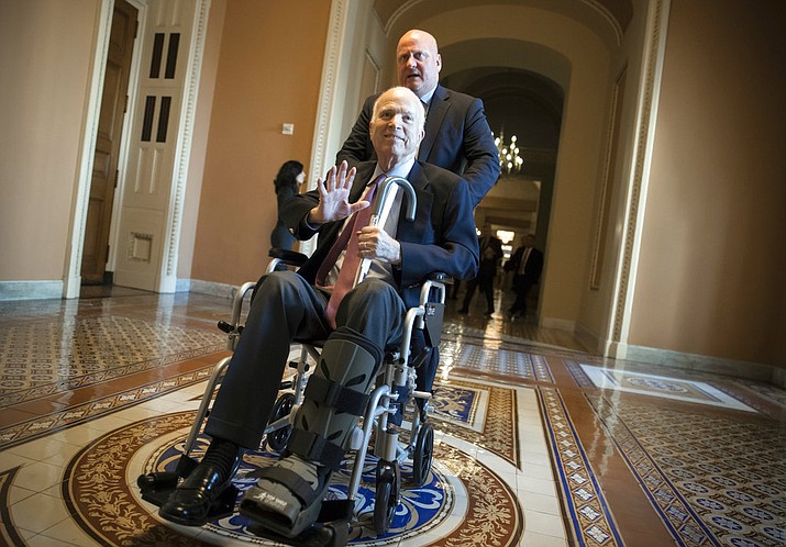 File - Sen. John McCain, R-Ariz., leaves a Dec. 1 closed-door session where Republican senators met on the GOP effort to overhaul the tax code, on Capitol Hill in Washington. President Donald Trump told reporters Sunday that McCain is returning home to Arizona after being hospitalized for the side effects of his brain cancer treatment and likely will miss a crucial vote on the GOP tax package. (AP Photo/J. Scott Applewhite) 