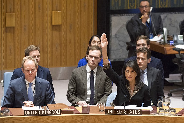 In this photo, U.S. Ambassador to the United Nations Nikki Haley, right, votes against a resolution concerning Jerusalem's status at U.N. headquarters. The United States on Monday vetoed a resolution supported by the 14 other U.N. Security Council members that would have required President Donald Trump to rescind his declaration of Jerusalem as the capital of Israel, a vote that showed the depth of global opposition to the U.S. move. (Eskinder Debebe/United Nations via AP)
