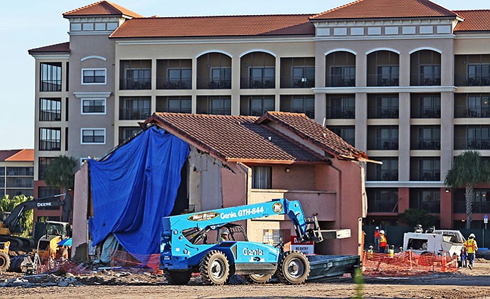 This photo taken May 26, 2016, shows new construction around the townhouse of an 81-year-old widow who refuses to sell home to Westgate Resorts in Orlando. According to records filed this week, Westgate Lakes LLC paid Julieta Meija de Corridor about $1.5 million for her property. (Red Huber/Orlando Sentinel via AP)