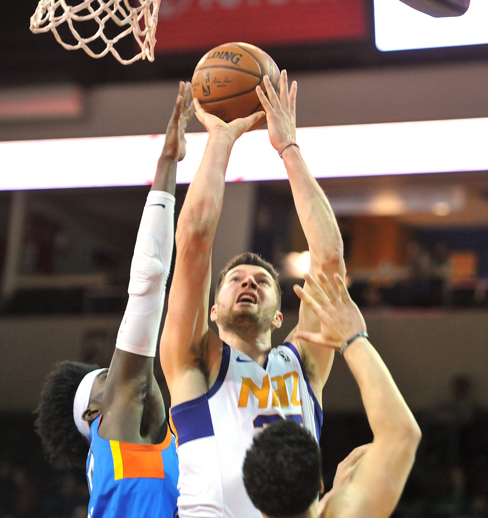 Northern Arizona's Alec Peters goes over two defenders as the Suns take on the Oklahoma City Blue Friday night at the Prescott Valley Event Center.  (Les Stukenberg/Courier)