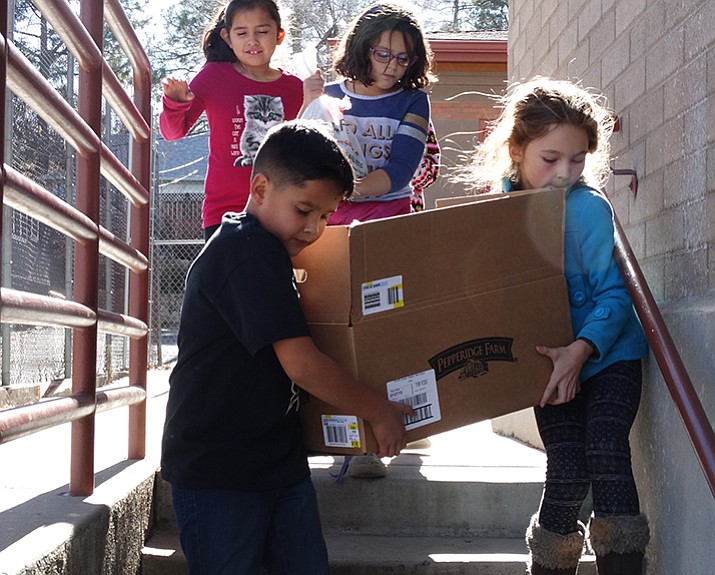 Lincoln School students move some of the food items they collected to donate to a food pantry. (Courtesy PUSD)