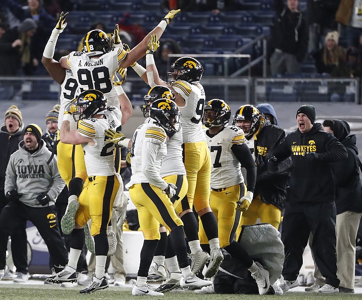 Iowa players and coaches celebrate after Iowa defensive end Anthony Nelson (98) forced a crucial game-changing fumble after sacking Boston College quarterback Darius Wade during the fourth quarter of the Pinstripe Bowl NCAA college football game, Wednesday, Dec. 27, 2017, in New York. Iowa scored after the fumble to defeat Boston College 27-20. (Kathy Willens/AP)