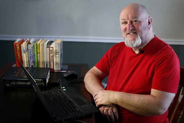 In this photo made Monday, Dec. 11, 2017, Chris Strolin poses for a photo in Belleville, Ill. Strolin created the online Omnificent English Dictionary in Limerick Form, or OEDILF for short, and with the help of contributors has published more than 97,000 definitions of words in limerick form since it began in 2004. (AP Photo/Jeff Roberson)

