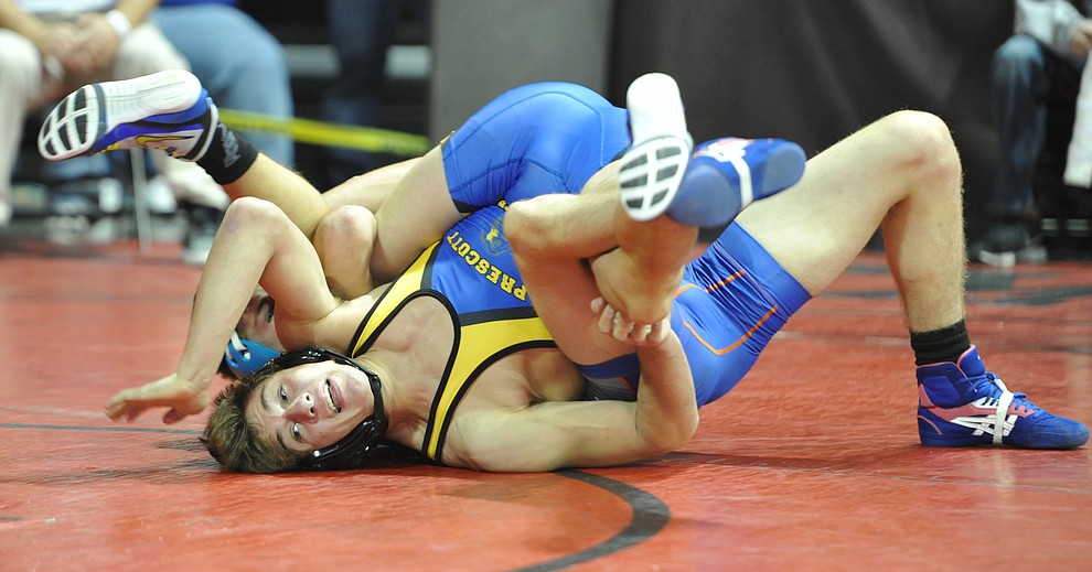  Chino Valley's JC Mortenson wrestles Prescott's Koby Coates in one of the most entertaining matches in the Mile High Challenge consolation bracket Saturday afternoon at the Prescott Valley Event Center. Coates ended up victorious in a back and forth match. (Les Stukenberg/Courier)