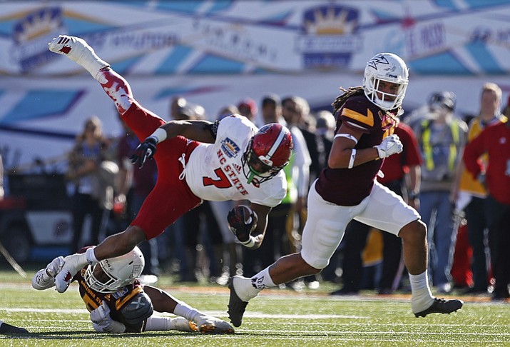 North Carolina State running back Nyheim Hines (7) is tackled by Arizona State defensive back Kobe Williams (5) during the first half Friday, Dec. 29, 2017, in El Paso, Texas. (Andres Leighton/AP)