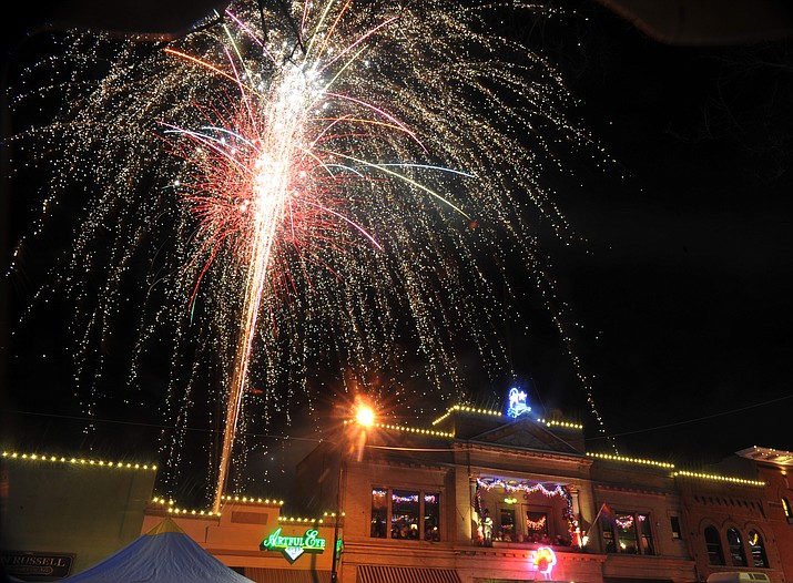 Fireworks light the sky during the 7th annual New Year's eve Whiskey Row Boot Drop in Prescott Sunday night.  (Les Stukenberg/Courier)