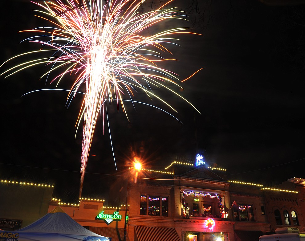 Fireworks light the sky during the 7th annual New Year's eve Whiskey Row Boot Drop in Prescott Sunday night.  (Les Stukenberg/Courier)