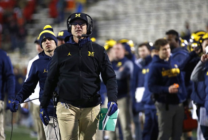 Michigan coach Jim Harbaugh takes his team into today’s Outback Bowl against South Carolina. Both teams are trying for a 9-win season. (Patrick Semansky, AP File)