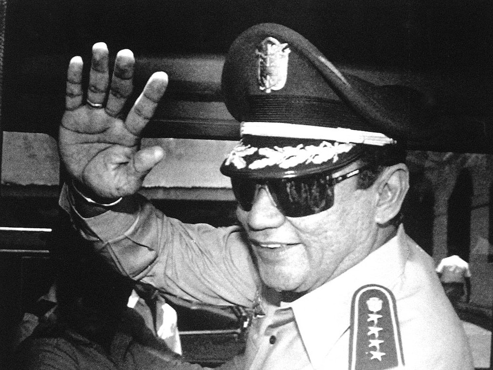 FILE - In this Aug. 31, 1989 file photo, Gen. Manuel Antonio Noriega waves to the press after a state council meeting at the presidential palace in Panama City, where the new president was announced. Noriega was among the notable figures who died in 2017. (AP Photo/Matias Recart, File)