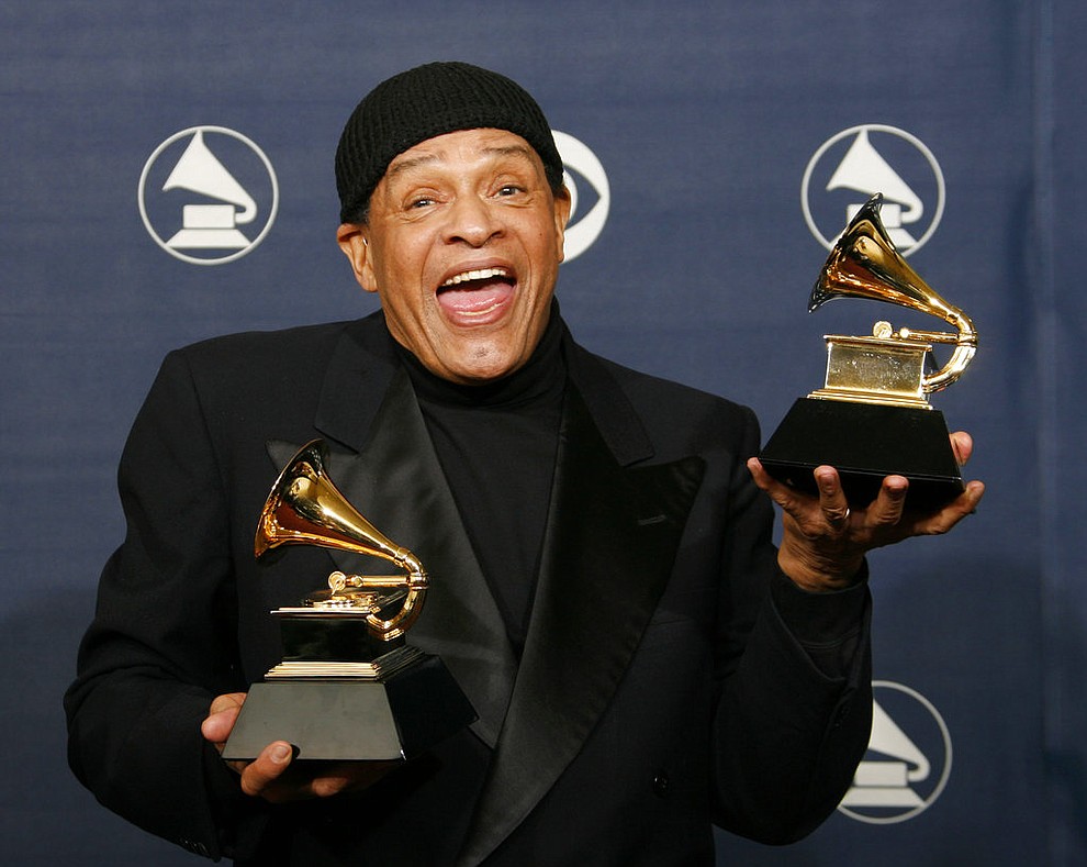 FILE - In this Sunday, Feb. 11, 2007, file photo, Al Jarreau poses with his awards for best pop instrumental performance for "Mornin'" and best traditional R&B vocal performance for "God Bless the Child" at the 49th Annual Grammy Awards in Los Angeles. Jarreau died in a Los Angeles hospital early Sunday, Feb. 12, 2017, according to his official Twitter account and website. (AP Photo/Kevork Djansezian, File)