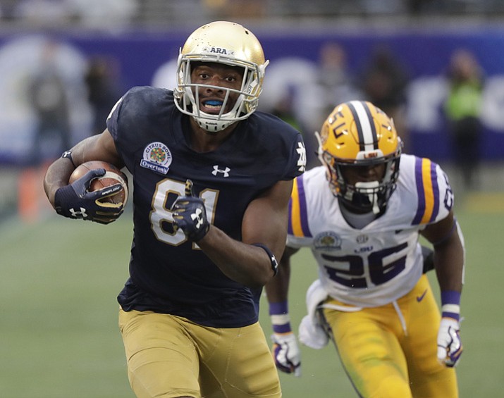 Notre Dame wide receiver Miles Boykin, left, runs to the end zone past LSU safety John Battle (26) on his way to the score the game-winning touchdown during the second half of the Citrus Bowl on Monday, Jan. 1, 2018, in Orlando, Fla. Notre Dame won 21-17. (John Raoux/AP)