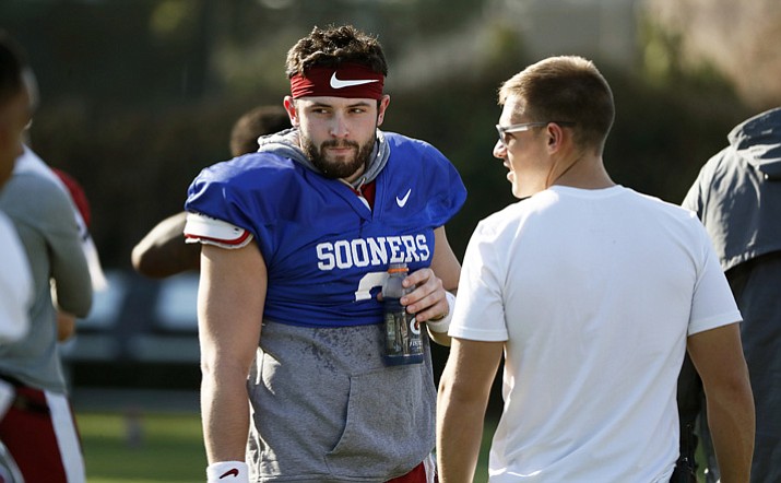 Oklahoma quarterback Baker Mayfield takes a breather after he participated in drills during a short segment of Rose Bowl practice that was open to the media, Friday, Dec. 29, 2017, in Carson, Calif. Oklahoma plays Georgia in a semifinal of the College Football Playoff on New Year's Day. (Bob Andres/Atlanta Journal-Constitution via AP)