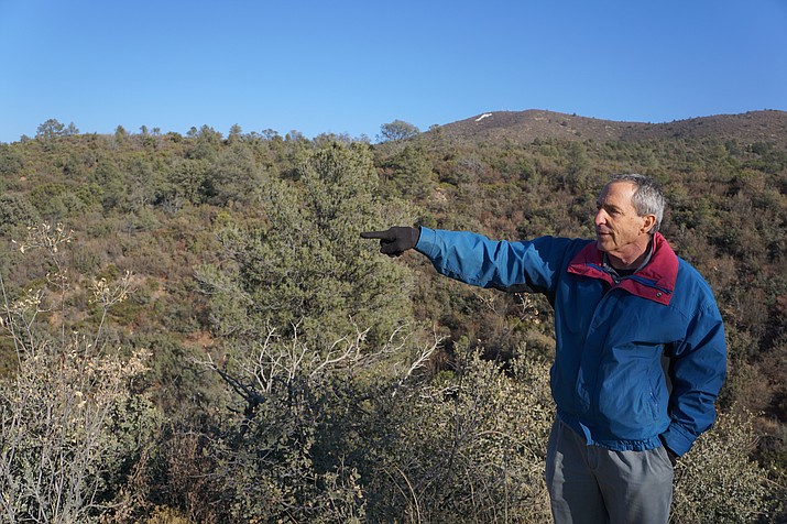 Local businessman Howard Mechanic points out the land along Overland Trail in the Government Canyon area where he hopes to develop a residential project. Because of the steep terrain, Mechanic says he plans to cluster the homes to preserve more of the parcel. In early December, Mechanic filed a complaint against the City of Prescott to acquire the water service to which he says the land is legally entitled. (Cindy Barks/Courier)