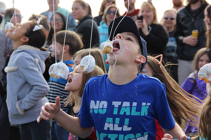 David Richards put in a good effort during the no-hands donut eating contest at this year’s Polar Bear Splash in Prescott Valley on Saturday, Jan. 6. (Max Efrein/Courier)
