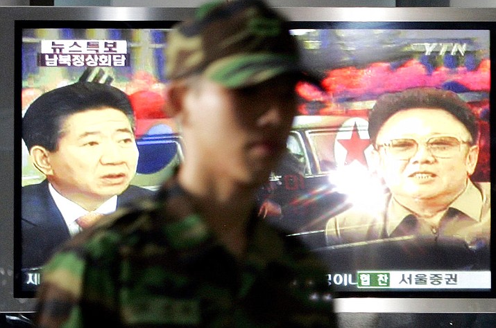 FILE - In this Wednesday, Aug. 8, 2007, file photo, South Korean soldier walks past a large TV broadcasting news about a summit between North and South Korea, at the Seoul Railway Station in Seoul, South Korea. (AP Photo/ Lee Jin-man, File)

