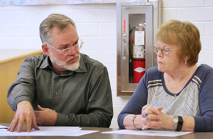 Jim Ledbetter tells fellow members of the Advisory Committee for Consolidation that Warner Report author David Bolger had offered to update the 2012 report based on the two – not three – districts that it now pertains to. Also pictured, committee member Janice Rollins. (Photo by Bill Helm)