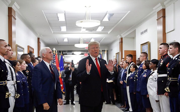 In this July 20, 2017, file photo, President Donald Trump stops to answer a reporter's question after greeting military personnel during a visit to the Pentagon. Watching is Vice President Mike Pence. With Russia in mind, the Trump administration is aiming to develop new nuclear firepower that it says will make it easier to deter threats to European allies. The plan, not yet approved by President Donald Trump, is intended to make nuclear conflict less likely, but critics argue it would do the opposite. (AP Photo/Pablo Martinez Monsivais)

