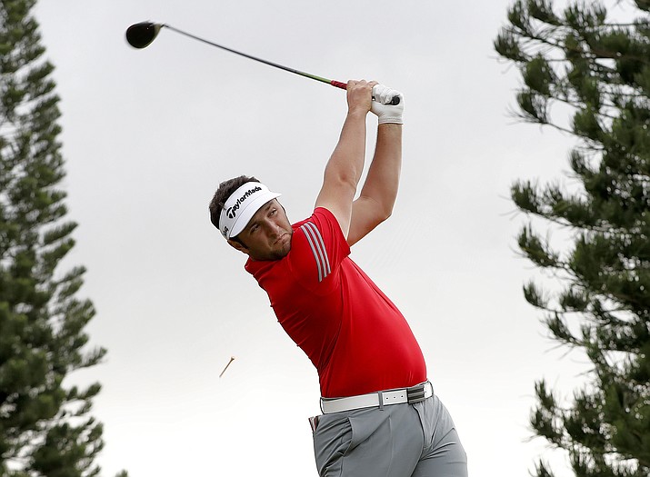 Jon Rahm plays his shot from the 18th tee during the final round of the Tournament of Champions golf event Sunday, Jan. 7, 2018, at Kapalua Plantation Course in Kapalua, Hawaii. Rahm gave 18-year-old Charlie Reiter some pointers entering the CareerBuilder Open this weekend. (Matt York/AP, File)