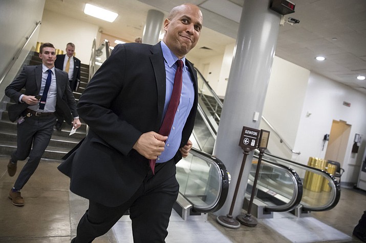 Sen. Cory Booker, D-N.J., runs to catch a subway car as he returns to his office on Capitol Hill as Congress moves closer to the deadline to avoid a government shutdown, in Washington, Thursday, Jan. 18, 2018. (AP Photo/J. Scott Applewhite)

