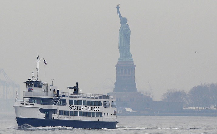 A Statue of Liberty and Ellis Island tour boat passes by the Statue of Liberty after dropping passengers off there, Monday, Jan. 22, 2018, in New York, after resuming service early Monday during the government shutdown. The Statue of Liberty and Ellis Island opened for visitors Monday, with New York state picking up the tab for the federal workers. (AP Photo/Kathy Willens)