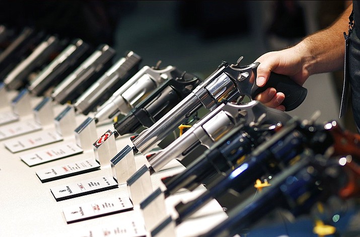 In this Jan. 19, 2016 file photo, handguns are displayed at the Smith & Wesson booth at the Shooting, Hunting and Outdoor Trade Show in Las Vegas. The largest gun industry trade show will be taking place in Las Vegas Jan. 23-26 just a few miles from where a gunman carried out the deadliest mass shooting in modern U.S. history. (AP Photo/John Locher, File)

