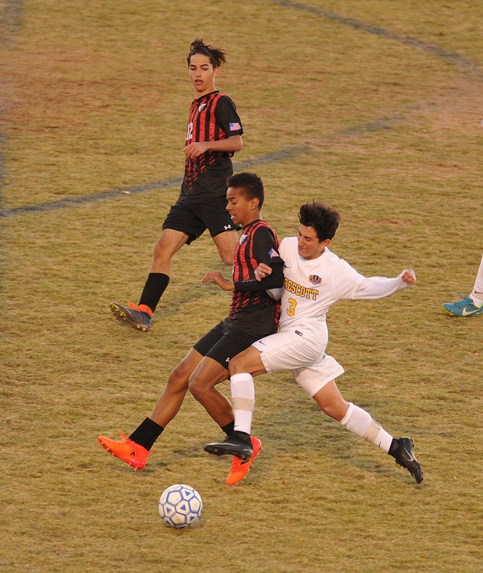 Prescott's Stefon Nevarez battles with Aaron Akins as the Badgers hosted cross town rival Bradshaw Mountain in a soccer double header Tuesday in Prescott. (Les Stukenberg/Courier)