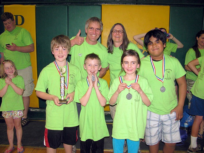 Andy and SuZan Pearce give a thumbs up after Grand Canyon students win medals at an Odyssey of the Mind competition.