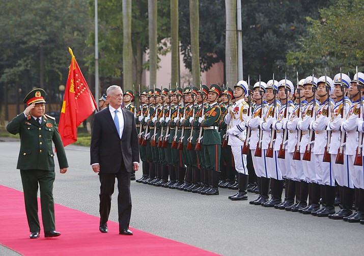 U.S. Defense Secretary Jim Mattis, right and his Vietnamese counterpart Ngo Xuan Lich, left, review an honor guard before heading for talks in Hanoi, Vietnam, Thursday, Jan. 25, 2018. Mattis is on a two-day visit to Vietnam to boost military ties between the two countries. (AP Photo/Tran Van Minh)