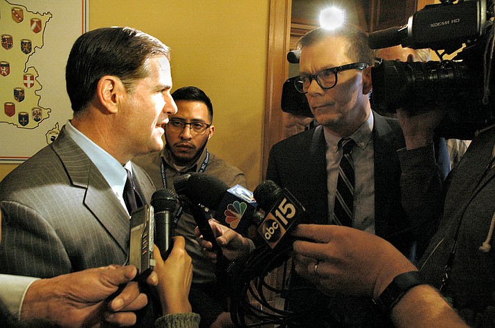 Gov. Doug Ducey takes questions from reporters Friday after signing into law major changes in Arizona laws dealing with opioids, both legal and otherwise. (Capitol Media Services/Howard Fischer)