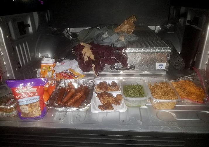 This Wednesday, Jan, 24, 2018, photo provided by the Jefferson County Sheriff’s Office in Beaumont, Texas, shows home-cooked treats taken from federal inmate Joshua Hansen, after he escaped from a federal prison near Beaumont with the intention of breaking back in laden with a duffle bag with bottles of alcohol and home-cooked treats. He was arrested Jan. 24, as he ran onto private land near the prison. (Jefferson County Sheriff’s Office via AP)

