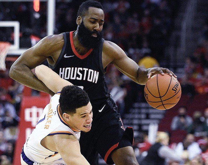 Houston Rockets guard James Harden, right, collides with Phoenix Suns guard Devin Booker during the first half Sunday, Jan. 28, 2018, in Houston. (Eric Christian Smith/AP)