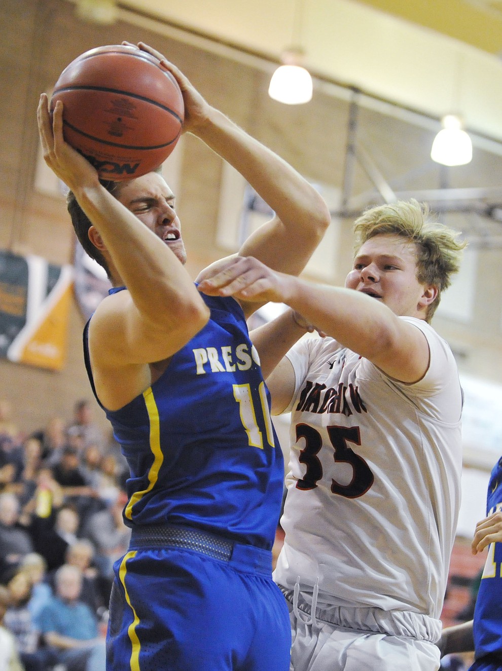 Prescott's Kody Jones gets fouled by Travis Lamb as the Badgers traveled to crosstown rival Bradshaw Mountain Tuesday night in Prescott Valley. (Les Stukenberg/Courier)