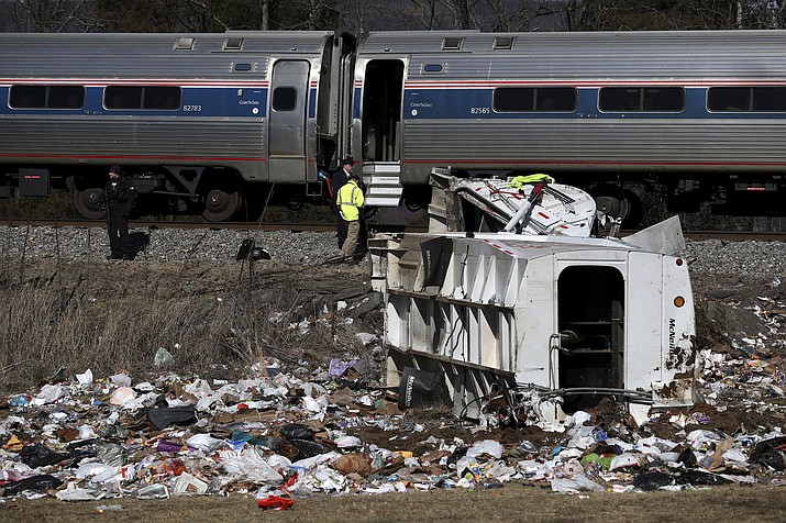 Emergency personnel work at the scene of a train crash involving a garbage truck in Crozet, Va., on Wednesday, Jan. 31, 2018. An Amtrak passenger train carrying dozens of GOP lawmakers to a Republican retreat in West Virginia struck a garbage truck south of Charlottesville, Va. No lawmakers were believed injured. (Zack Wajsgrasu/The Daily Progress via AP)

