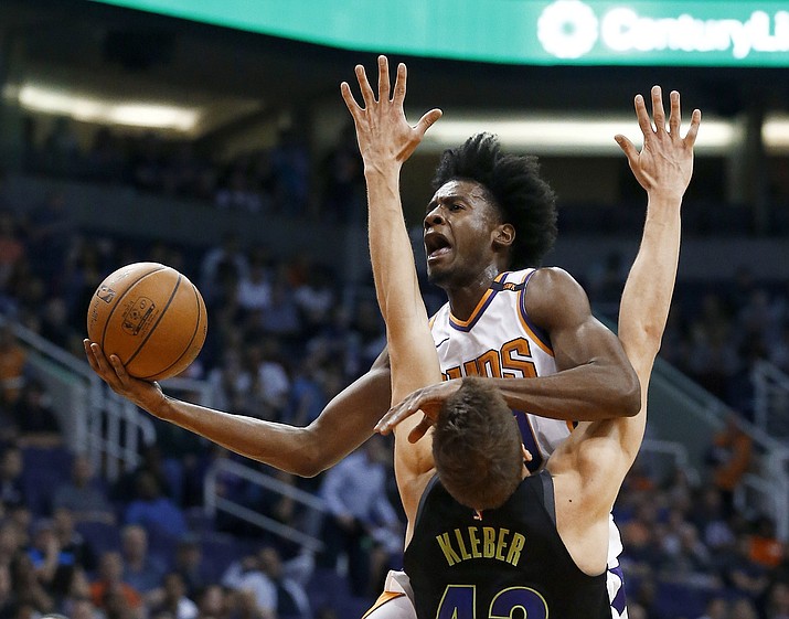 Phoenix Suns forward Josh Jackson drives as Dallas Mavericks forward Maximilian Kleber (42)) defends, while Suns forward TJ Warren (12) watches during the first half Wednesday, Jan. 31, 2018, in Phoenix. (Ross D. Franklin/AP)