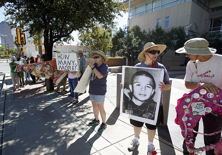 Supporters from a number of humanitarian groups, in this Friday, Oct. 9, 2015 file photo, gather at a vigil for border shooting victim José Antonio Elena Rodríguez in front of the federal courthouse in Tucson, preceding the arraignment of Border Patrol Agent Lonnie Swartz in the October 2012 shooting. (Ron Medvescek/Arizona Daily Star via AP, File)