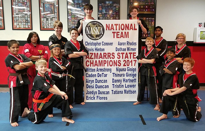 Team KC’s poses with their 2017 Championship Banner that will hang in the dojo. (Photo courtesy KC’s Family Tae Kwon Do in Cottonwood)