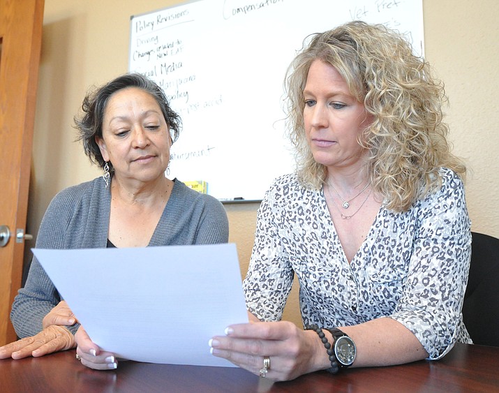 Yavapai County Human Resources manager Esther Hunt and Director of Human Resources and Risk Management Wendy Ross show one of the initial steps when investigating a sexual harrasment complaint is to read the initial claim report to determine what steps to take from there. (Les Stukenberg/Courier)