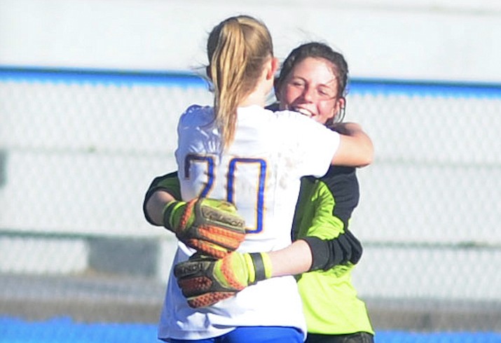 Prescott's Mikayla Sell (20) and goalkeeper Olivia Fletcher embrace after a match Feb. 4, 2017. Sell scored a goal and Fletcher had 11 saves in a 1-0 win over No. 3-ranked Estrella Foothills in the quarterfinals of the 4A state playoffs Saturday, Feb. 3, 2018, in Goodyear. (Les Stukenberg/Courier, File)