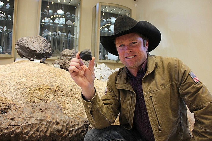 Local meteorite hunter Robert Ward shows off the most recent addition to his collection, a meteorite he found atop the frozen lake near Hamburg, Michigan.