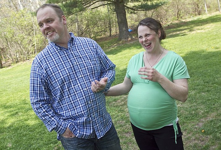 In this May 6, 2015 file photo, Kateri and Jay Schwandt stand outside their Rockford, Mich. home. The couple, who have 13 boys, are expecting their 14th child, due in April of 2018. They’ve decided not to know until the baby is born whether it’s a boy or girl. (Chris Clark/The Grand Rapids Press via AP, File)

