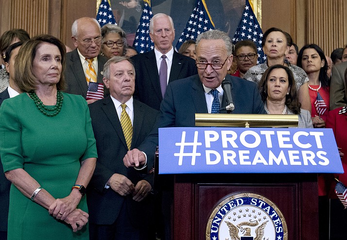In this Sept. 6, 2017, file photo, Senate Minority Leader Chuck Schumer, of N.Y., accompanied by House Minority Leader Nancy Pelosi, of Calif., at left, and others members of the House and Senate Democrats, speaks during a news conference on Capitol Hill in Washington. ( AP Photo/Jose Luis Magana)