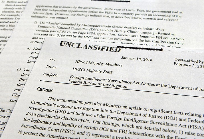 A intelligence memo is photographed in Washington, Friday, Feb. 2, 2018. After President Donald Trump declassified the memo, the Republican-led House Intelligence Committee released the memo based on classified information that alleges the FBI abused U.S. government surveillance powers in its investigation into Russian election interference.(AP Photo/Susan Walsh)