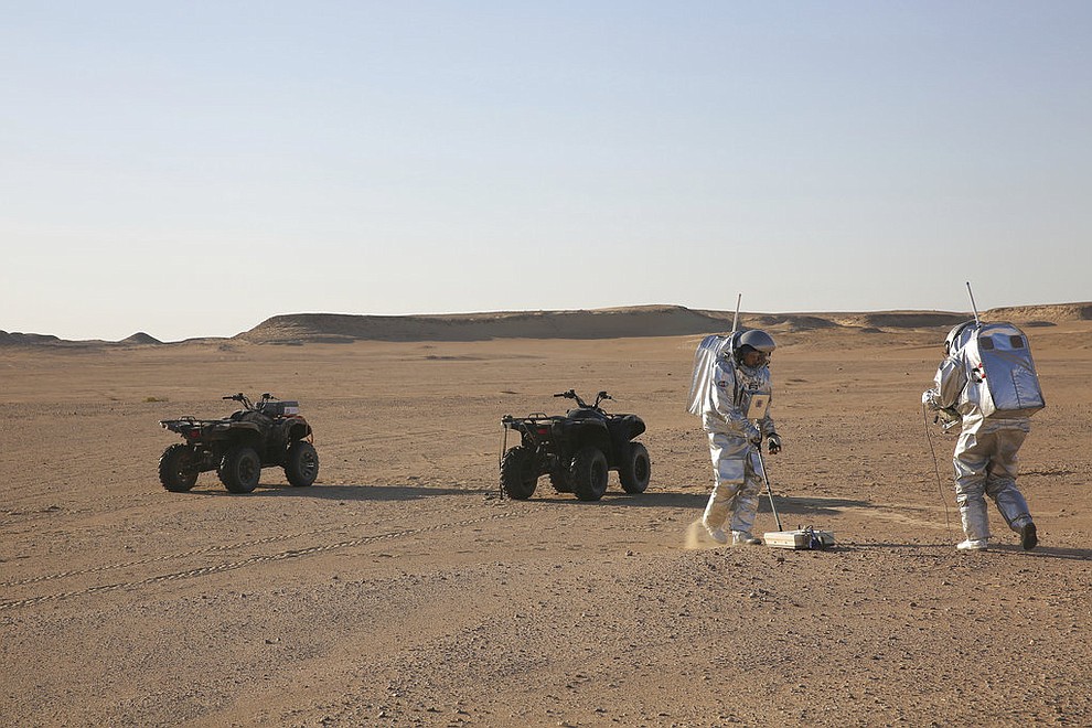In this Feb. 7, 2018, photo, two scientists test space suits and a geo-radar for use in a future Mars mission in the Dhofar desert of southern Oman. The desolate desert in southern Oman resembles Mars so much that more than 200 scientists from 25 nations organized by the Austrian Space Forum are using it for the next four weeks to field-test technology for a manned mission to Mars. (AP Photo/Sam McNeil)